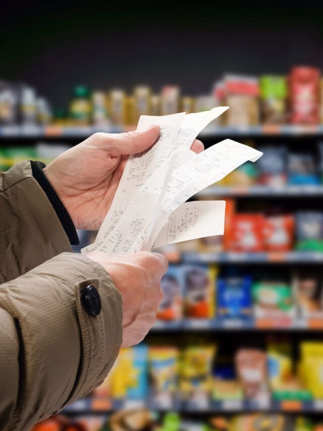 Homem confere extrato em supermercado que afeta o INPC acumulado 2022